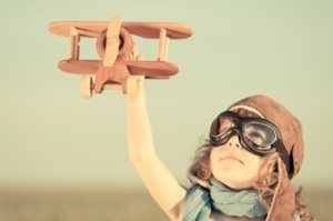 A kid playing with a toy airplane