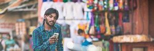 Man with a cell phone in a market