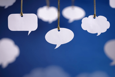 Paper speech bubbles hanging from above