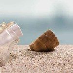 A message in a bottle on a sandy beach.