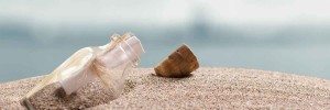 A message in a bottle on a sandy beach.