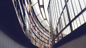 A curved library wall of books