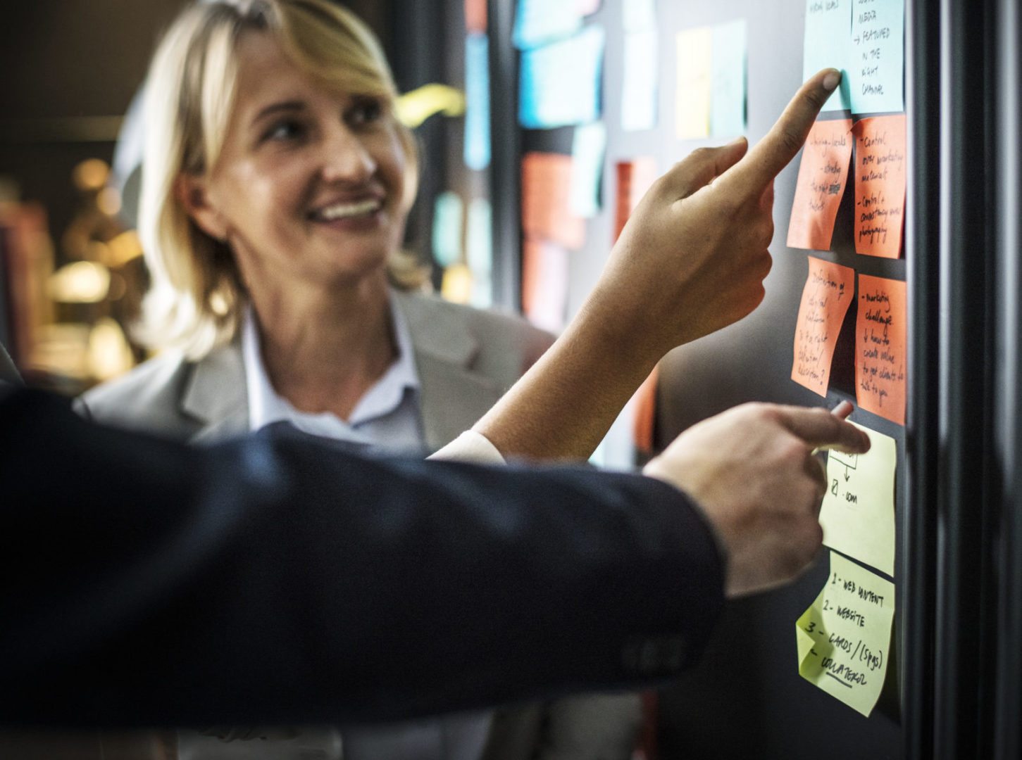 Collaborating at a board with sticky notes